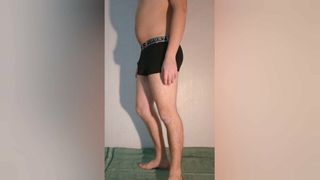 The guy shows how the chastity belt looks in boxer briefs