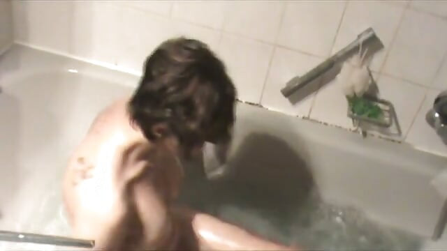 Brunette MILF with big boobs and round ass masturbating in the bathtub