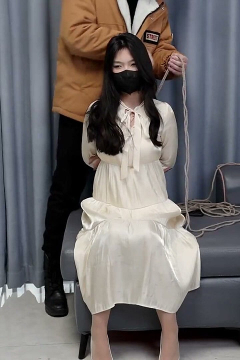 Girlfriend in a Dress and Stockings, Bound by Rope