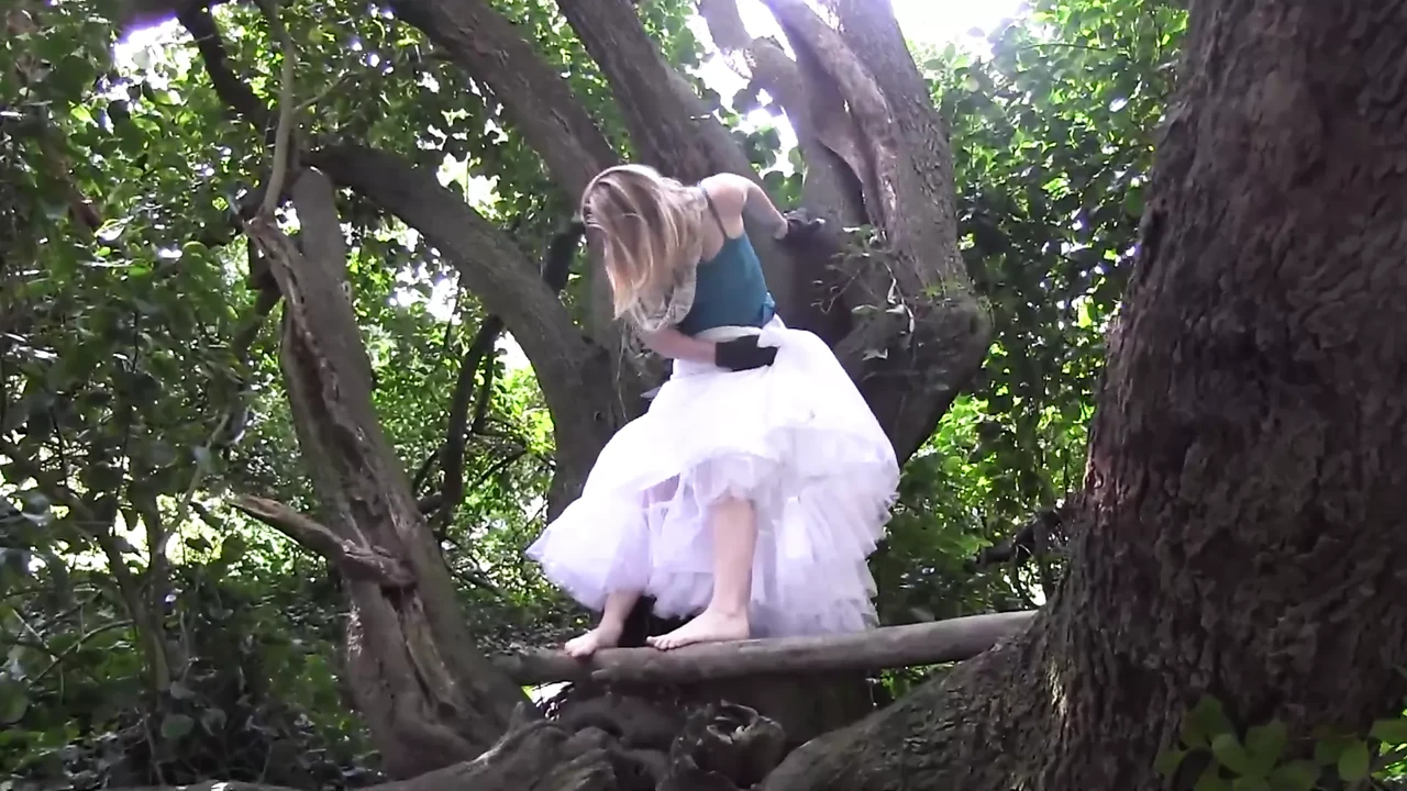 crazy slut climbs a tree and wildly rubs her pussy on the branch