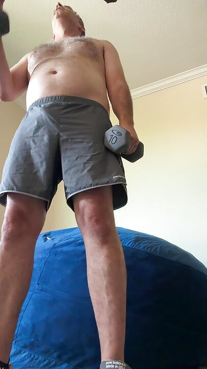 Lifting weights with my shirt off. My big sexy hairy chest is out in full force