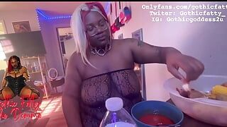Ebony BBW stuffs her face while she is topless
