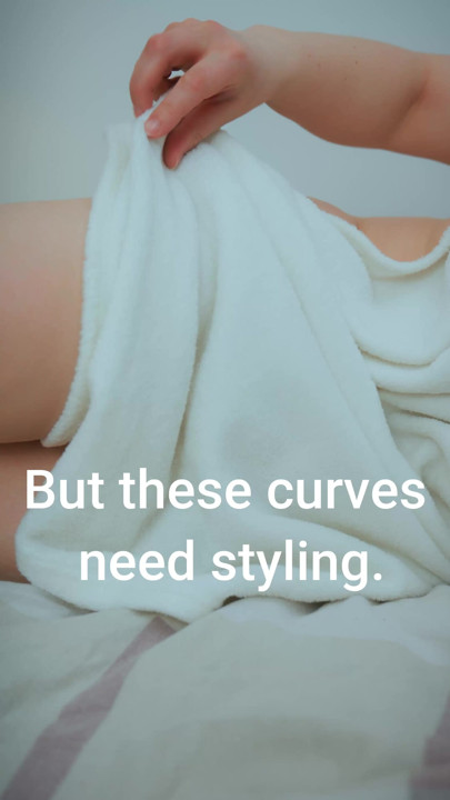 A MILF is posing as a queen in a white blanket. Someone should tell her that those breasts are beautiful