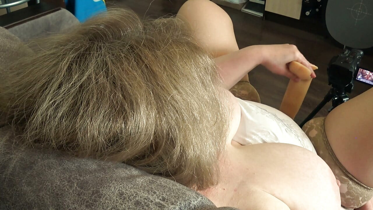 Big Tits From Above. a Camera Watches From the Side as a Plump MILF Masturbates and Records a Video.