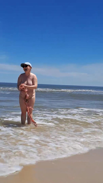Amateur filming. A nudist plays with waves on the ocean shore. | Clip 1