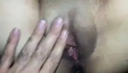 Fingering her fleshy pussy