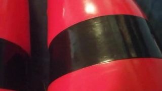 Shiny red latex rubber stockings closeup