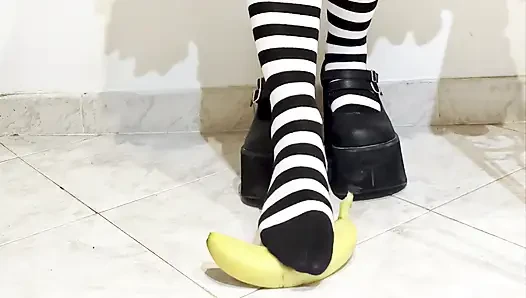 Goth crushing a banana under her shoes