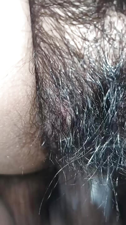 Close up view on a hairy and creamy pussy
