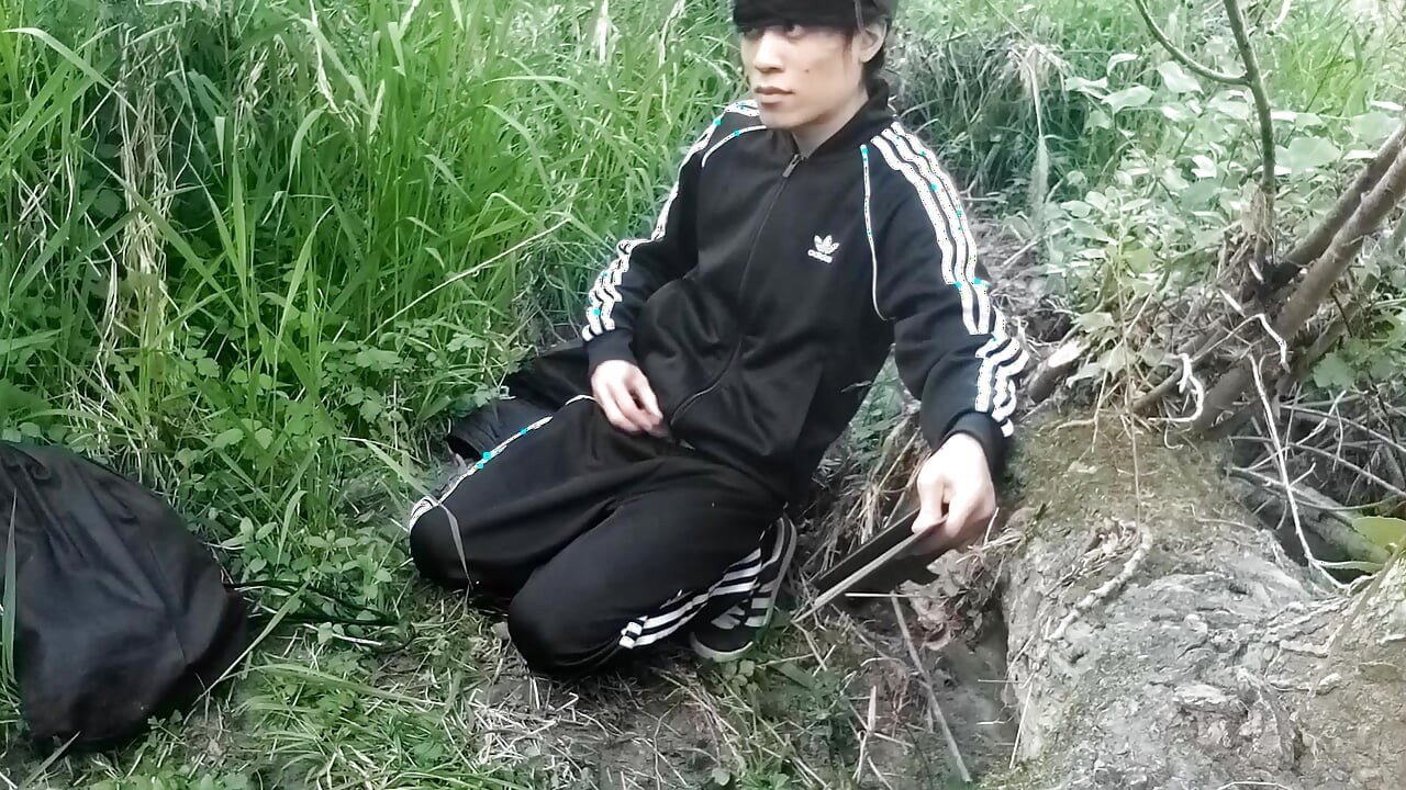 Cute Asian gay twink in a black-and-white adidas tracksuit and Campus sneakers masturbates and cums outdoors