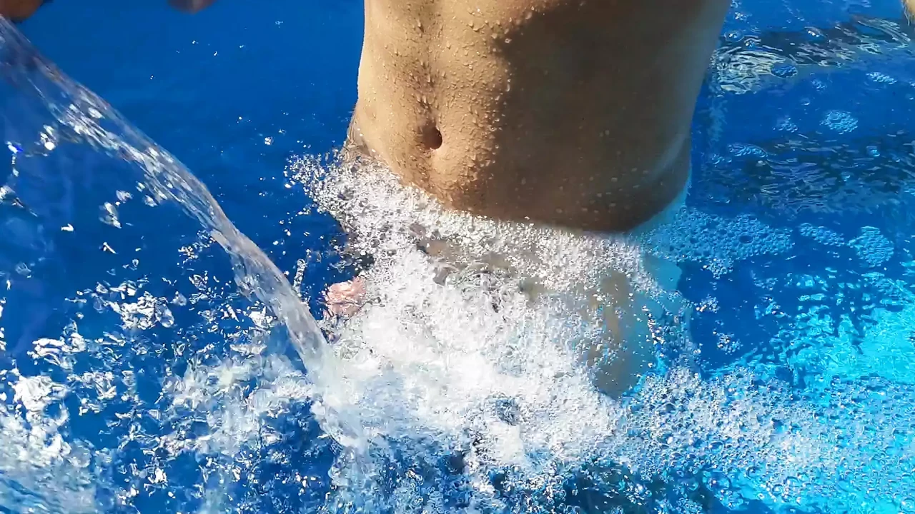 German Guy in the swimming pool enjoying the Waterfall