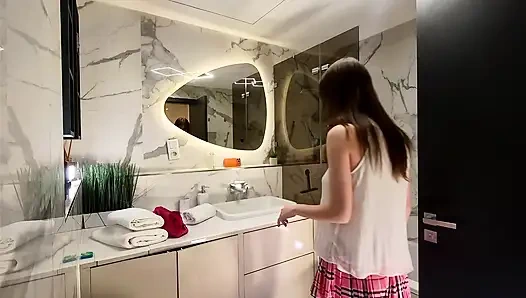 Long legs nerdy college girl with a short skirt and panties shows off in the bathroom