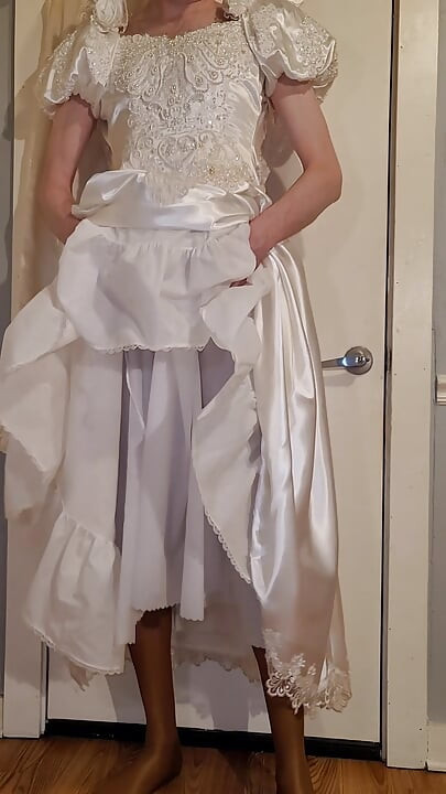 Trying on a liquid satin wedding dress.
