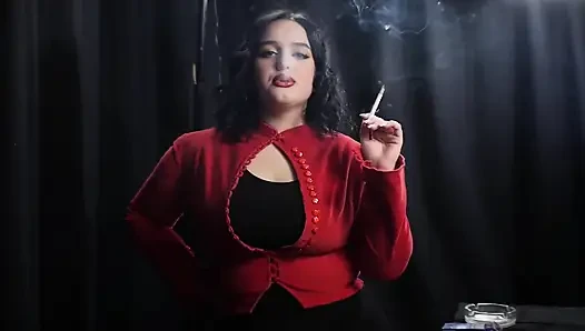 Tombul esmer kırmızı cardigan içinde sigara içiyor
