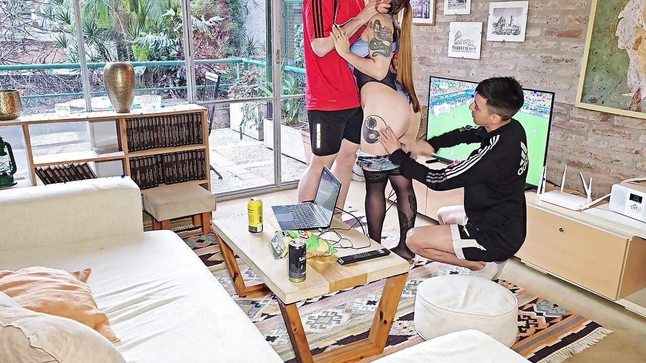 Two men fuck a hot wife so they can watch the game: double penetration.