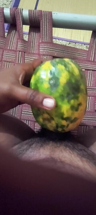 An Indian man enjoys the pleasure of inserting his penis into a papaya fruit