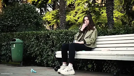 Young Brunette Is Taking an Unhurried Stroll with Allwhite 120mm Cigarette
