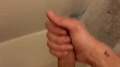 Young slim twink strokes big cock, squirts in the shower.