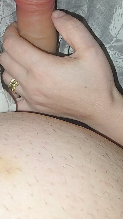 Step sister surprises step brother with a handjob while they watch a movie