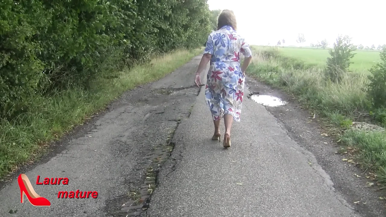 walking naked with nylons , high heels down the street.