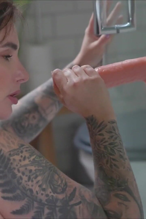 Paige in Her Bathroom While She's Sucking off One of Her Cock Dildos