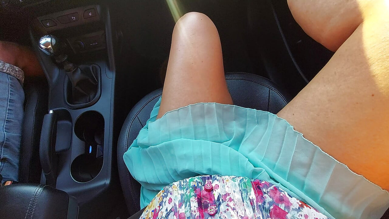 An attractive and elegant MILF with sexy legs in high heels and a short skirt, in a taxi, in the morning