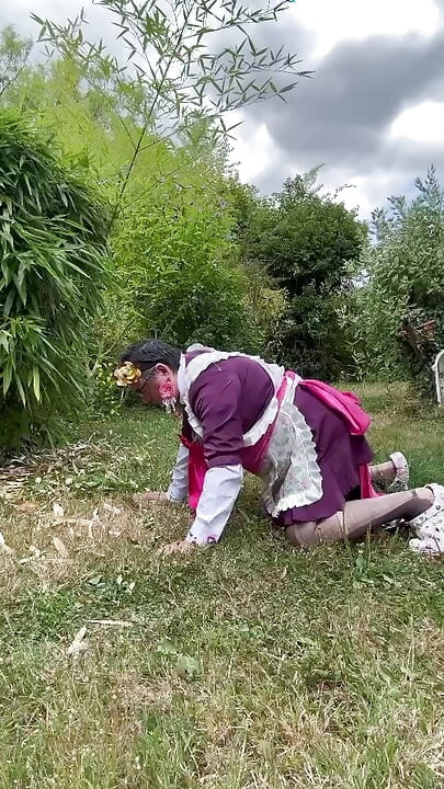 In gardener's outfit, peeing on all fours like a dog