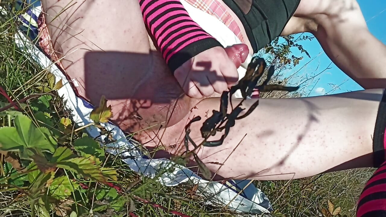 A young, sexy, and depraved sissy slut strips naked in the woods and greedily fucks herself.