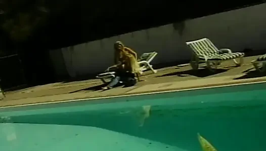 Petite blonde lesbians having fun by the pool