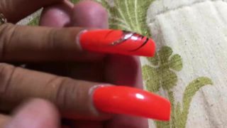 Latina with sexy long orange nails fingernails