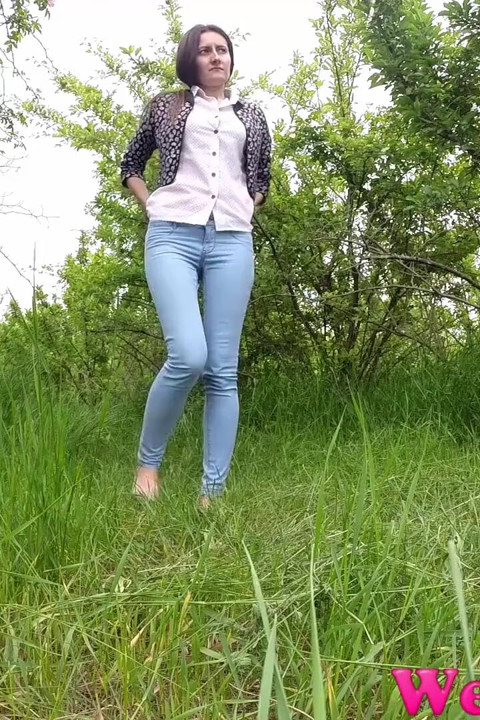 Peeing next to some flowered trees