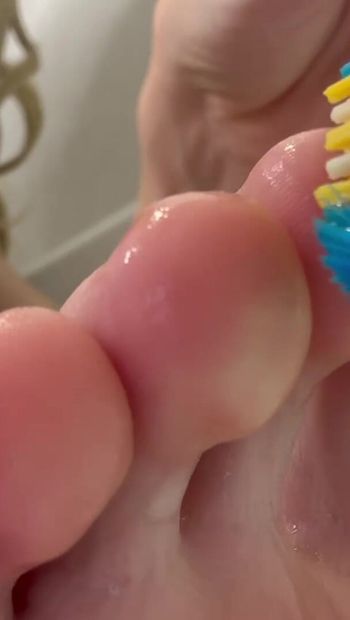 Tickling big feet with a toothbrush - do you want to tickle my legs? I love this