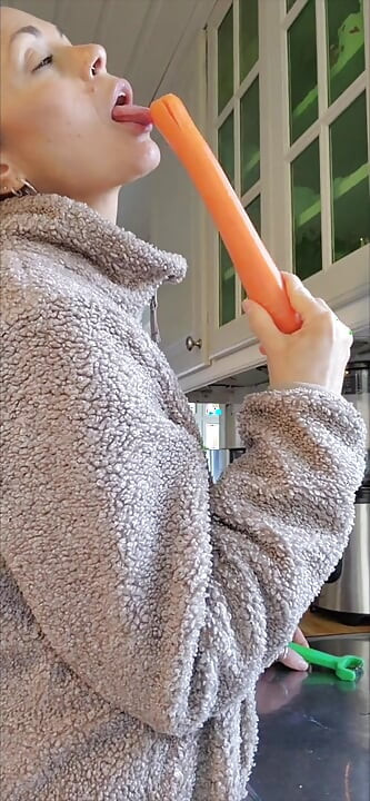 Angelina is cooking with carrots and she can't help treating them with her special spice.