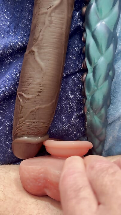 The latex titty slut pushes three monstrous dildos in a row!