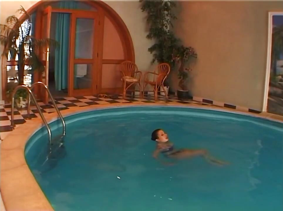 Drilling cute woman next to a swimming pool