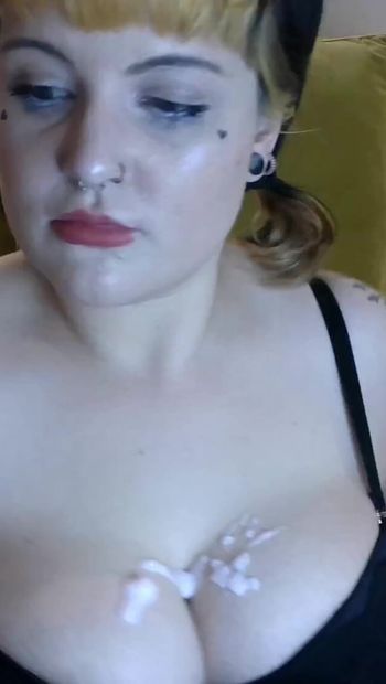 Goth girl puts lotion on boobs