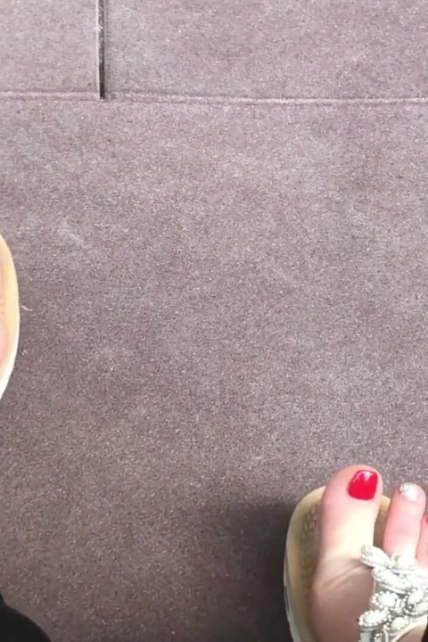 Sandals teasing outdoor with red toenails & toes wiggling