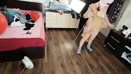 Amateur woman has fun trying on clothes and cutting them.