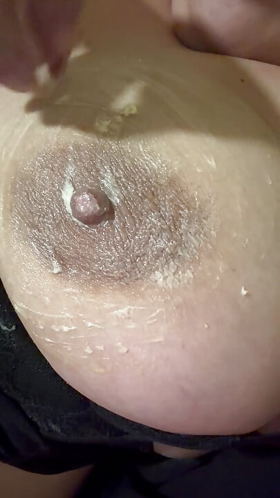 Hot sexy blonde fills her huge nipple with cream