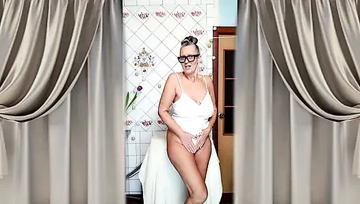 Hot mature housewife Lukerya undresses and teases with her huge tits in the kitchen