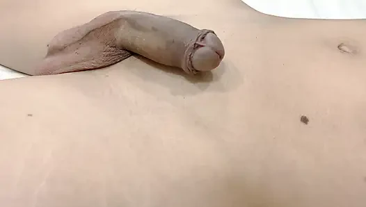 A boy with a large foreskin gets an erection, masturbates, and cums twice