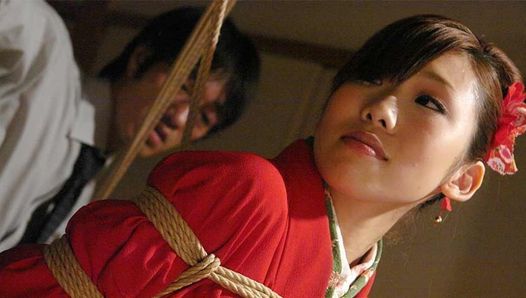 Tied up Asian bimbo sucks two cocks and gets toyed