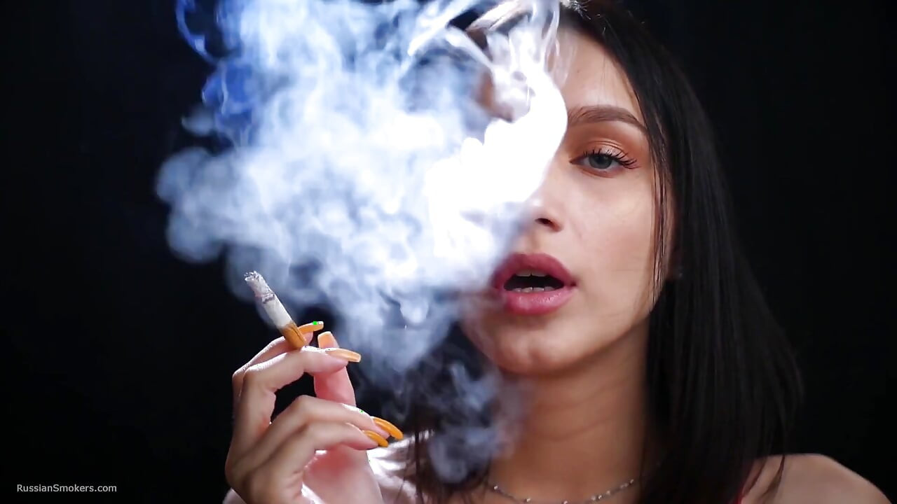 Sexy Lady in Red Is Smoking Two 100mm Reds