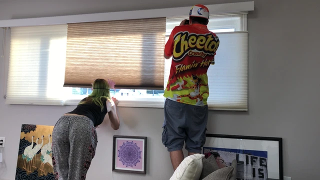 Couple Peeping Outside Apartment Window