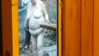 Fat mature wife brings in firewood 