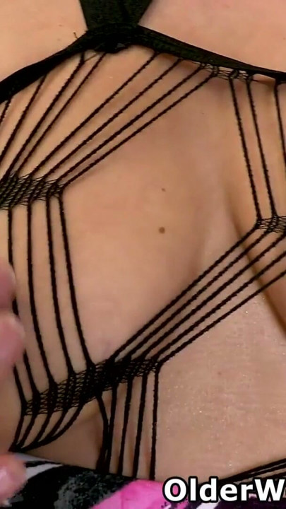 British milf Lelani wears a spider web body stocking and fucks her wet cunt with a dildo | Clip 1