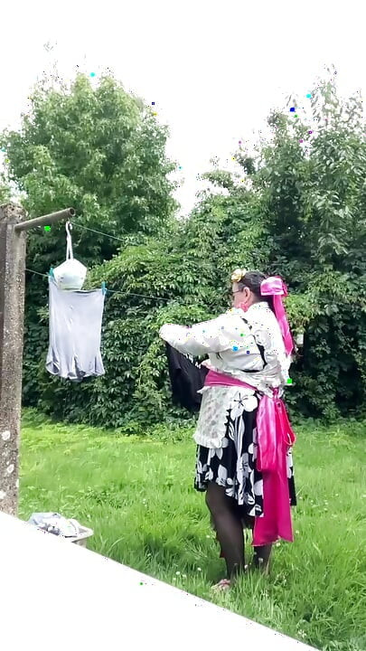 In gardening outfit to hang the laundry