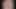 A redhead seduces her audience with the introduction of a giant dildo