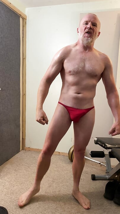 Oleada muscle daddy flexionando em posers vermelhos, em seguida, fica nu e masturba seu grande pau de 7 polegadas.
