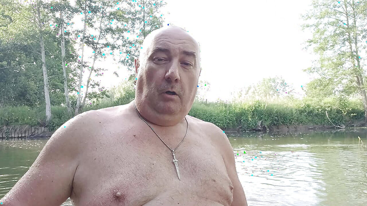 The plump, mustachioed daddy is having a blast in the stream, shamelessly masturbating with mud